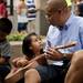 Dug Song (right) and his daughter Quynh, two, play with an instrument at the "petting zoo" of the Dancing in the Streets Festival on Sunday. Daniel Brenner I AnnArbor.com